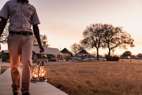 Wilderness Linkwasha is a luxurious camp that lies in a private concession in the enormously productive south-eastern corner of Hwange National Park. Situated on the edge of the famed Ngamo Plains, which offers fantastic summer game viewing, the camp looks over a magnificent plain and a pan that is a magnet for game year round, especially in the dry winter months.

The fresh, open and airy design of Wilderness Linkwasha is complemented by an eclectic mix of contemporary interiors. Nine luxurious en-suite tents (eight twins and one family unit) offer incredible views, while the main area – including multi-level decks, a pool area and a winter lounge complete with library – overlooks the prolific waterhole.

Insider’s Tip: Enjoy the thrill of getting your feet on the ground on a walking safari in the company of Wilderness Linkwasha’s knowledgeable and highly experienced safari guides. 
