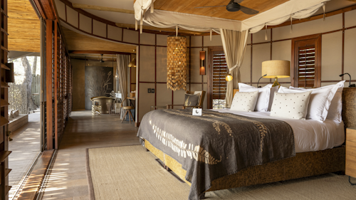 Wilderness Mombo, on Mombo Island just off the northern tip of Chief’s Island, is built under large shady trees and overlooks a wonderful floodplain teeming with wildlife. 

Accommodation comprises eight spacious suites raised off the ground, all built to maximize the vistas over the plains. Each tent is elegantly furnished, complete with en-suite bathroom, a dressing area, indoor and outdoor showers; as well as a bathtub that creates a sense of indulgence. The expanded deck includes a sala and plunge pool.

A large living and dining area looks out over that same view, while Wilderness Mombo’s famous traditional dinners are hosted in the nearby boma. Wilderness Mombo shares a Safari Boutique, spa, gym and lap pool with Wilderness Little Mombo. Large concentrations of plains game often occur in front of camp, and you may see a variety of animals without even leaving the veranda.

Insider’s Tip: Arguably the best big game viewing in all of Africa with a bountiful hunting ground for large prides of lions and leopards.
