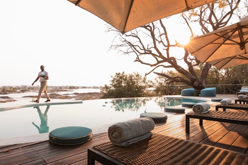 On the banks of the Zambezi River, Wilderness Toka Leya is far enough from Livingstone to ensure a tranquil, authentic bush experience, yet close enough for guests to enjoy all the many activities in the greater Victoria Falls area. Wilderness Toka Leya can be all about adrenaline, or an opportunity to relax and unwind before or after a safari. 

Wilderness Toka Leya has twelve luxurious tents (of which three are family tents). Each has a sumptuous outdoor bath, while the wellness centre with yoga and meditation options complements the serene surroundings. Boating and catch-and-release fishing excursions bring the Zambezi experience to life. 

Insider’s Tip: Reconnect with nature by enjoying a massage treatment on the banks of the Zambezi River!