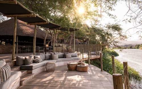 Set amongst shady trees on the banks of the Kunene River, Wilderness Serra Cafema is one of the most remote camps in southern Africa, its Portuguese name originating from the mountains that dominate the northern skyline. Guests fall asleep to the sound of rushing water, while by day they explore one of the driest deserts in the world.

Activities here are varied, including boating (water levels permitting), walking, viewing breathtaking landscapes, as well as carefully guided quad-bike excursions that tread lightly on the dunes. In this isolated region, the Himba people continue their nomadic, traditional way of life and when in the area, guests have the opportunity to meet them and learn about their lifestyle and traditions.

Insider's Tip: Most authentic Himba cultural experience in all of Namibia!