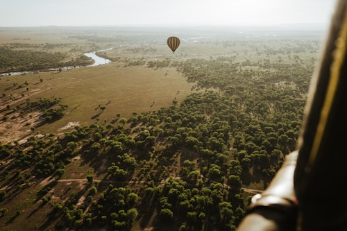 Embark on a once-in-a-lifetime adventure with Serengeti Balloon Safaris. With over 30 years of experience, the company provides a bird's eye view of the stunning landscapes and iconic wildlife that define this safari hotspot.

Your adventure begins early, with a 4 AM start, and featuring an exciting drive in the dark from your camp to the designated take-off spot. Keep an eye out for the chance to spot elusive nocturnal creatures in motion. As the burners roar and the balloon's giant envelope fills with hot air, your heart races as the balloon gracefully ascends into the sky. 

Over the course of an hour, you will be treated to extraordinary views over the Serengeti, before descending for a traditional champagne toast. 

Relive the magic of your journey over a classic bush breakfast served under an iconic acacia tree, complete with fine bone china crockery. Throughout the experience, you will have the opportunity to learn about hot air balloon navigation in all three dimensions, while the low burner noise ensures minimal disturbance to the wildlife below. Your morning comes to an end at 9:45 AM, as you receive your Serengeti balloon certificate and continue your day of adventure.

After breakfast, you receive your Serengeti Balloon certificate and later meet up with your safari driver at approximately 09:45 ready to continue your days activities.