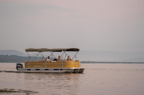 Every day at Akagera National Park offers the chance to explore some of East Africa's most breathtaking landscapes, from expansive savannah and lush woodland to tranquil lakes and grassy rolling hills. Encounter Africa's wildlife up close, including the Big Five, high hippo densities and impressive crocodiles. 

Enjoy twice daily game drives through Akagera's diverse terrain, keeping a keen eye out for majestic lions and cantankerous black rhinos, which thrive in this exclusive-use area. And as the sun sets, head out on a night drive to witness the park's nocturnal wonders come to life. 

For a more intimate experience, join guided walking safaris and uncover the hidden treasures of Akagera, or glide across the serene lake on a boating safari, keeping an eye out for elephants or even a unique fishing leopard.