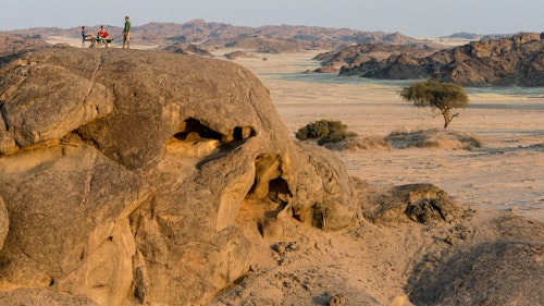 Located at the confluence of two tributaries in a broad valley of the Kaokoveld Desert, Hoanib Skeleton Coast Camp offers an unforgettable gateway from which to experience both the thrillingly desolate Skeleton Coast and the private Palmwag Concession, alive with desert-adapted wildlife.

One of the highlights here is a unique day trip excursion which sees you drive to the Skeleton Coast, stopping at oases and seeing wildlife along the way. You’ll get to explore the coastline, see seals and discover a shipwreck, before having lunch and then being flown back to camp so you can see the route you came from the sky.

Unravel the mysterious history of the original ancient Strandloper people and the enigmatic stone circles they left behind and encounter the welwitschia on a nature walk – one of the oldest and strangest plants on the planet.