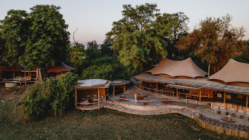 Wilderness Mombo, on Mombo Island just off the northern tip of Chief’s Island, is built under large shady trees and overlooks a wonderful floodplain teeming with wildlife. 

Accommodation comprises eight spacious suites raised off the ground, all built to maximize the vistas over the plains. Each tent is elegantly furnished, complete with en-suite bathroom, a dressing area, indoor and outdoor showers; as well as a bathtub that creates a sense of indulgence. The expanded deck includes a sala and plunge pool.

A large living and dining area looks out over that same view, while Wilderness Mombo’s famous traditional dinners are hosted in the nearby boma. Wilderness Mombo shares a Safari Boutique, spa, gym and lap pool with Wilderness Little Mombo. Large concentrations of plains game often occur in front of camp, and you may see a variety of animals without even leaving the veranda.

Insider’s Tip: Arguably the best big game viewing in all of Africa with a bountiful hunting ground for large prides of lions and leopards.
