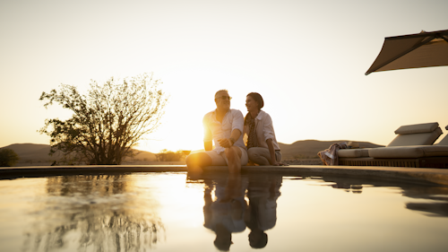 Designed for desert wanderers, Wilderness Desert Rhino Camp offers an original, exclusive wilderness experience and the opportunity to see free-ranging desert-adapted black rhino. The desert plains are starkly scenic, and home to other unique species, from Hartmann’s zebra and giraffe, to the bizarre welwitschia plant.

Styled with the desert in mind, the palette, textures and wildlife of Damaraland’s extraordinary vistas are brought into the elegant suite interiors.

With natural stone found on site reinforcing the camp’s connection to nature, Desert Rhino Camp evokes a real sense of place in this stark desert landscape.

Six suites with deep overhanging stretch fabric roof structures, interior tones of terracotta, sage, fern greens and cream, complemented by classic details of timber and leather, create a sheltered sanctuary within this breath-taking desert landscape.

Run in conjunction with Save the Rhino Trust Namibia, Wilderness Desert Rhino Camp offers rhino tracking by vehicle and on foot with experts from this conservation NGO.

Insider's Tip: Explore this extraordinary landscape in search of desert-adapted wildlife and gain amazing insight into the ecology and conservation of this area. A picnic lunch is the perfect complement to your day’s outing!