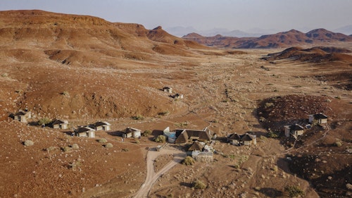 The Huab River Valley lies in one of the best wilderness areas in Namibia, offering endless vistas of plains, valleys and mountains. Wilderness Damaraland Camp is run in partnership with the Torra Conservancy and visits to the local farmstead reveal the fruits of this very positive relationship. 

Each of the ten spacious en-suite, adobe-style thatched accommodations (including a family unit) has a large private viewing deck. New technology and ancient knowledge makes for an ultra-light footprint; nature drives and guided walks offer sights of desert-adapted wildlife, ancient rock-art and striking geological formations. Astonishing night skies round out each day’s experiences. 

Insider’s Tip: Meet members of the local village on a community visit and discover the inspiring story of how Wilderness Damaraland Camp came to be. 



