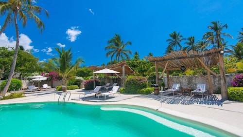 Set on one of the world’s best kitesurfing beaches, White Sand is an unspoilt and laidback slice of Zanzibar bliss. Eleven private and spacious villas are spread across four acres, promising complete beachside intimacy. Each villa boasts lots of lavish touches, from private pools and terraces to an outdoor bath and shower, to idyllic sea and tropical garden views.

Spend your days here lounging on the beautiful Paje beach and enjoying the top-class spa. Or, for those who fancy a little more action, try your hand at diving, swimming with dolphins and kitesurfing through the shallow, turquoise waters. Then, feast on scrumptious seafood at the fine dining restaurant and head up to the rooftop bar for awesome sunset views.

What’s more, White Sand Luxury Villas & Spa supports its environment and local community with investment in renewable energy and community projects.