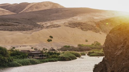 Set amongst shady trees on the banks of the Kunene River, Wilderness Serra Cafema is one of the most remote camps in southern Africa, its Portuguese name originating from the mountains that dominate the northern skyline. Guests fall asleep to the sound of rushing water, while by day they explore one of the driest deserts in the world.

Activities here are varied, including boating (water levels permitting), walking, viewing breathtaking landscapes, as well as carefully guided quad-bike excursions that tread lightly on the dunes. In this isolated region, the Himba people continue their nomadic, traditional way of life and when in the area, guests have the opportunity to meet them and learn about their lifestyle and traditions.

Insider's Tip: Most authentic Himba cultural experience in all of Namibia!