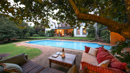 Tucked away in the leafy suburb of Karen, just 30 minutes from Jomo Kenyatta International Airport, Karen Gables offers a tranquil retreat from Nairobi’s bustle. Surrounded by verdant gardens and the gentle Ngong Hills, this Cape Dutch-style home provides a peaceful base with easy access to the city’s cultural highlights, shopping, and wildlife experiences.

The property features individually styled rooms and suites, each with en suite facilities and air-conditioning. Junior and Master Suites offer fireplaces, private lounges, and garden views, while cosy Standard Doubles and Twins are perfect for a restful night’s sleep. Wi-Fi, in-room safes, and daily housekeeping ensure a comfortable stay, while the solar-heated pool and multiple private nooks around the gardens provide inviting spaces to relax and unwind.

Explore Nairobi’s attractions with ease, from the Rothschild’s giraffes at the AFEW Giraffe Centre and the baby elephants at the David Sheldrick Wildlife Trust, to the iconic Nairobi National Park just a short drive away. Local shopping, dining, and the historic Karen Blixen House are also close at hand. A six-seater Toyota LandCruiser is available for excursions, ensuring safe and flexible transport.

Insider’s Tip: Ask for the Junior Suite overlooking the terraced gardens; early mornings bring a serene view of birds and butterflies fluttering across the lawns, a quiet moment before heading out to explore Nairobi.