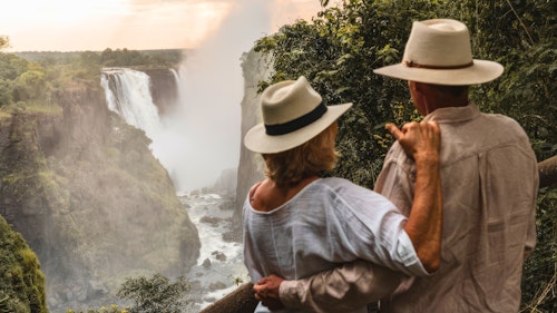 Witness the breathtaking majesty of Victoria Falls, a World Heritage Site straddling the borders of Zimbabwe and Zambia. 

As you stand before the most expansive curtain of water on Earth, experience the breathtaking "Smoke that Thunders," locally known as "Mosi-oa-Tunya."

From February to May each year, the Victoria Falls are in full flood and 500 million litres of water tumble over the edge into a series of gorges each minute! After a briefing and explanation of the Falls, your guide accompanies you along the 1.7-kilometre scenic pathways of the rainforest, stopping at numerous viewpoints to gaze at the Falls. 

This privately guided tour lasts approximately 1.5 - 2 hours.