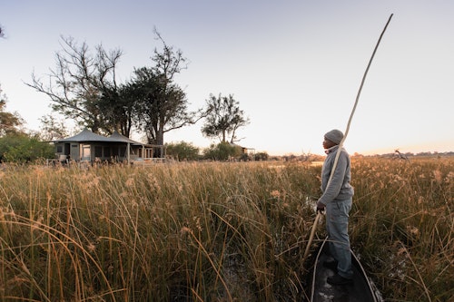 This small, intimate camp embodies all that is best about the Okavango Delta – breathtaking beauty, remote, peaceful island location, abundant game and varied landscapes. Add in the warm hospitality of the people of this region – who are stakeholders in the ecotourism success story of the Okavango – and you have a winning (and beautiful) combination.

With access to varied, game-rich habitats, this six-tented camp nestles beneath the trees of an ancient island forest. A floating jetty connects land with water, and the wildlife experience can include sightings of sable, and African wild dogs. 

Insider’s Tip: Float along a crystal-clear Okavango waterway by mokoro as you scan for reed frogs and water lilies. 


